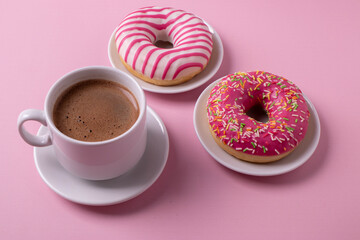 pink croissant and coffee on pink surface