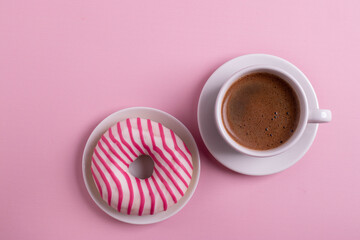 pink croissant and coffee on pink surface