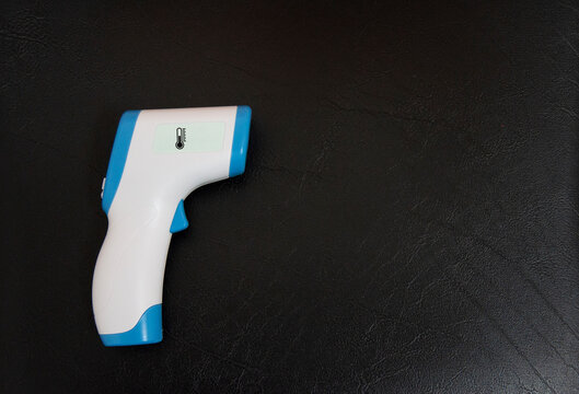 Digital Infrared Thermometer (thermometer gun) for check forehead temperature measurement scan from Coronavirus Pandemic 2019 (COVID-19). Isolated on black background. 