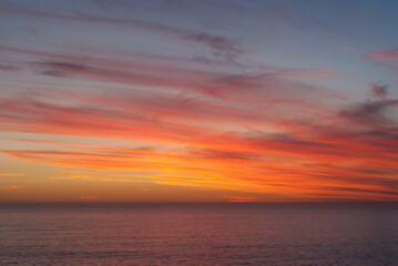 Naklejka na ściany i meble Beautiful colorful sunset over the ocean.