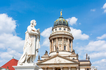 Fototapeta na wymiar Schiller monument and French Church dome on Gendarmenmarkt square, Berlin, Germany