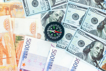 rubles dollars and euros with compass, the concept of currency volatility