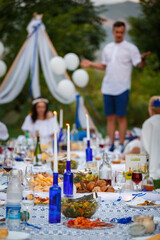 A candle in a blue bottle on the Banquet table