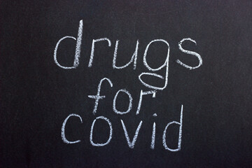 Fototapeta na wymiar Chalkboard text drugs for covid. What can help with coronavirus