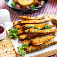 Kilka, Sprat fish, ketchup and other snacks on the table