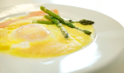 Fine dining food and drink being prepared and displayed in classic white crockery in a kitchen environment,