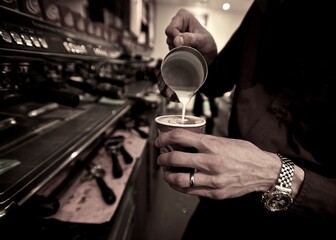 Male Barista making a cup of coffee,