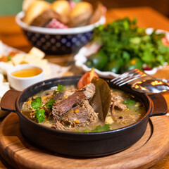 Tasty meat meal , soup on the black plate