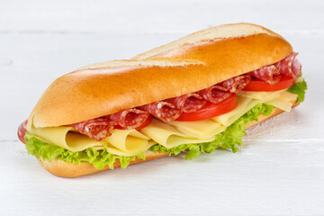 Sandwich baguette with salami ham and cheese fresh on wooden board