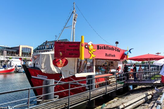 ROSTOCK, GERMANY - JUNE 14, 2020: fish bar &lsquo;Backfisch-Udo&rsquo; at the canal called &lsquo;Alter Strom&rsquo; (Old Channel) in the Warnem&uuml;nde district of the city of Rostock in Mecklenburg, Germany