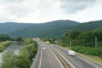 Aerial view of highway R1 in Zarnovica,  Slovakia direction Nitra with river Hron on the left hand side. The region is surrounded by Stiavnica Mountain range.