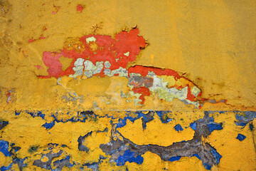  Weathered painted wall with colorful peeling textured paint in Rincon, Puerto Rico  