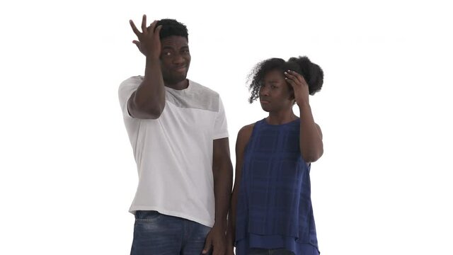 Portrait of confused African couple scratching their heads in bewilderment isolated on white background
