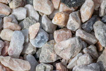 Raw rocks and minerals as natural stones background with crushed and rough material at a rough coast or rocky beach show nuggets and sandstones in harmonic pastel colors