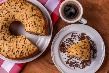 .Traditional Brazilian cake called Bolo Formigueiro. Vanilla cake with chocolate sprinkles. .Accompanied by a cup of coffee