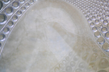 Abstract circle pattern in a glass brick as glass background shows a symmetric and elegant design in transparency like waves and fluent design in glass