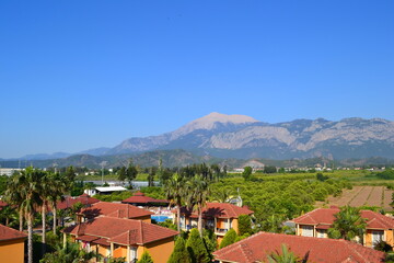 Fototapeta premium Mountains against a bright blue sky and beautiful clouds in summer
