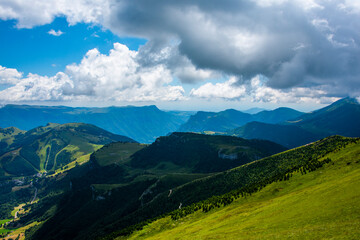 Naklejka premium flower fields mountain peaks and clouds five