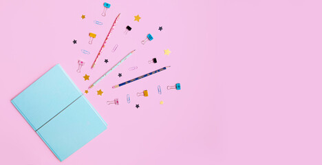School supplies flatlay on pink background. Back to school. School 2020. School banner with planner, book, clips, pen, stars, binder clips. Space for text. Place for text. Business banner background