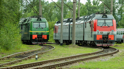 Obraz premium two electric trains standing on the railway tracks in the depot