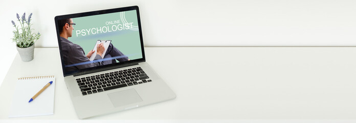 Video Conferencing With psychologist On Laptop Over Wooden Desk