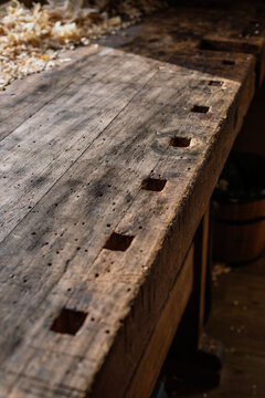High angle of wooden shabby template with marking square shaped holes for crafting violin details in workroom