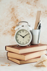 Stack of Books with Alarm Clock. Time for reading, concentration in study, homework or educational concept. Copy space