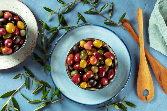 Olives. A variety of green, black and red olives, with leaves, shot from the top
