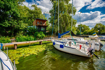 Fototapeta na wymiar River with blue water with a dock of yachts and boats. Dnepr, Kiev, Ukraine 
