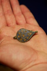 Archaeology artefact placed in the palm of a hand,