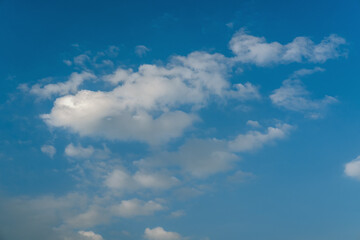 White clouds in blue azure sky. Summer good weather background.