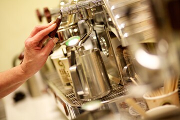 Fototapeta na wymiar Coffee machine mechanics as a barista prepares a coffee,