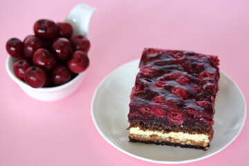 cake with cherry and fresh cherry fruits in bowl on pink background