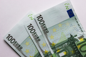 Close-up of 100 Euro banknotes isolated on white background. Currency, financial