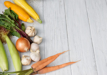 Harvest vegetables on white wooden background