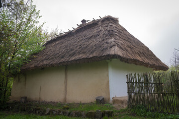 Fototapeta na wymiar Traditional Ukrainian clay house, hut with a reed roof