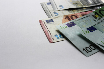 Close-up of euro banknotes on a white background. Currency, financial. Money concept. Flat lay, layout, top view. Economy, inflation