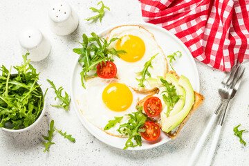 Healthy breakfast with egg, toast and salad.