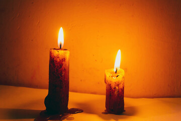 Two burning candles in the twilight