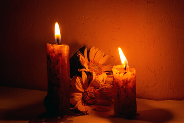 Two burning candles in the twilight of a vintage night room