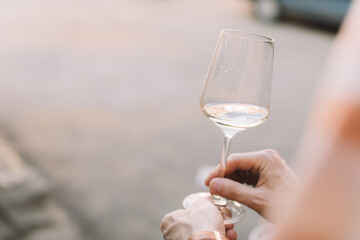 Man holding glass of wine at terrace. Copy space.
