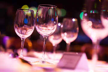 Wine glasses catching the light and becoming out of focus,