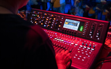 Sound technician control professional audio mixer in nightclub,Selective focus.