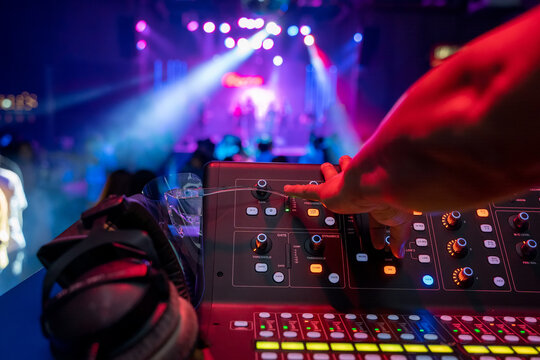 Sound technician control professional audio mixer in nightclub,Selective focus.