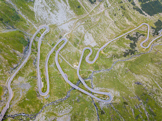 Beautiful long and curvy tarmac road viewed from a drone. 