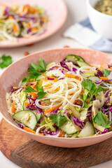 Vegetarian food. Salad with noodles, vegetables and sesame seeds in a bowl close-up. Tasty and healthy food.