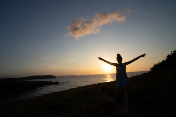 Fototapeta premium woman enjoying the sunset relaxing with a bow tie