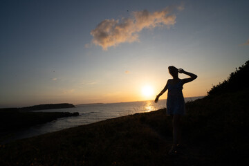 woman enjoying the sunset relaxing with a bow tie