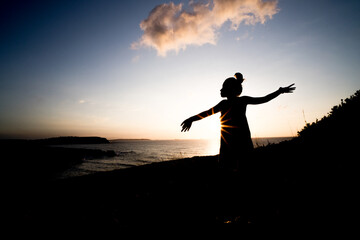 woman enjoying the sunset relaxing with a bow tie