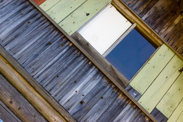 Geometric rustic wall background from old wooden boards and shields